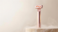 CALUNE One LED-inspired skincare ritual device standing on a porcelain stone pedestal